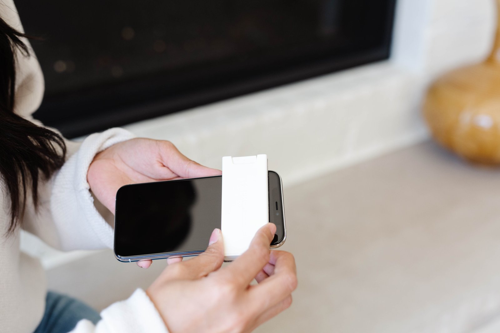 Wiping a phone screen with the built-in microfiber cloth