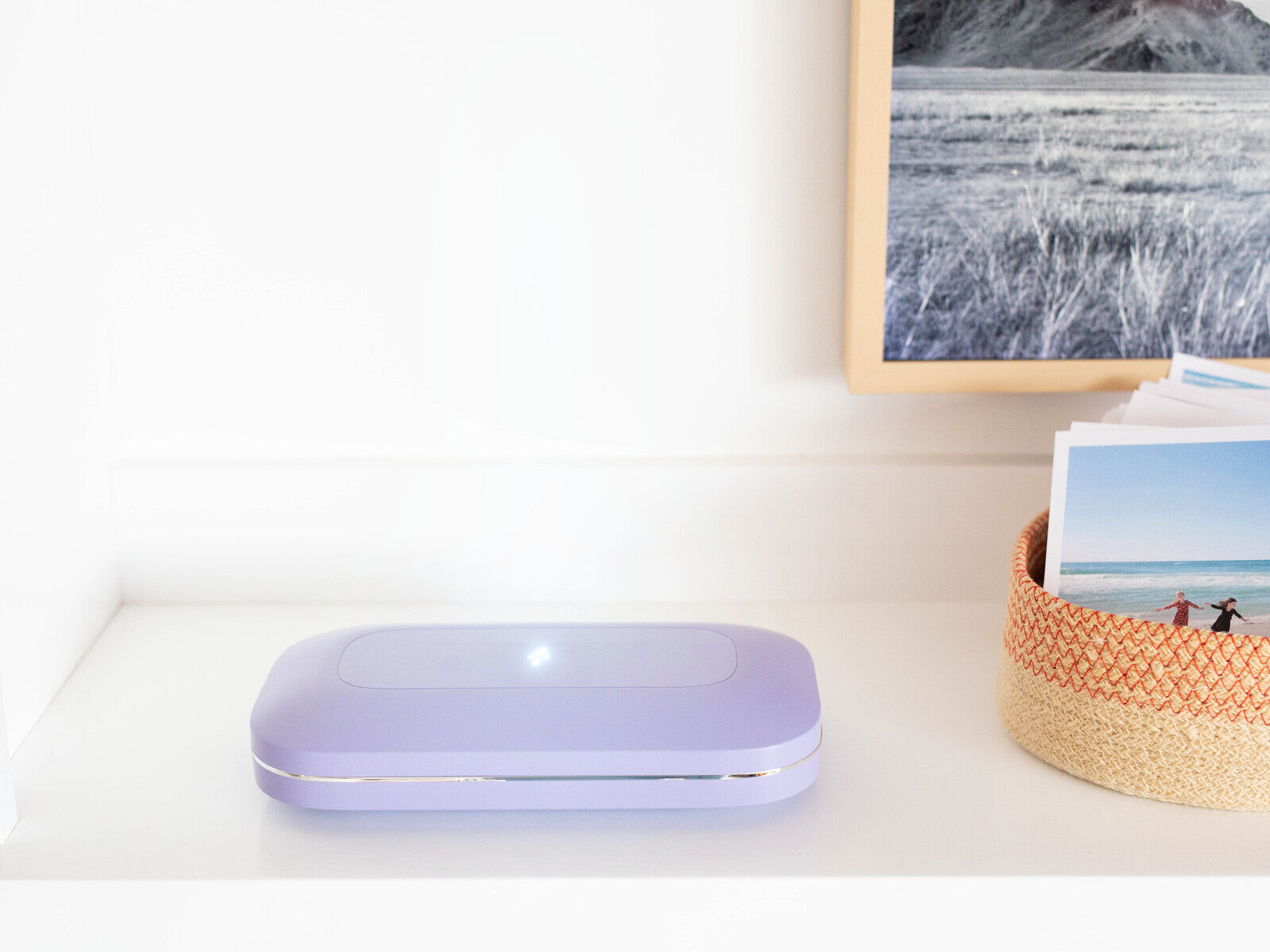 PhoneSoap Pro running its cycle with a soft blue glow from the bolt