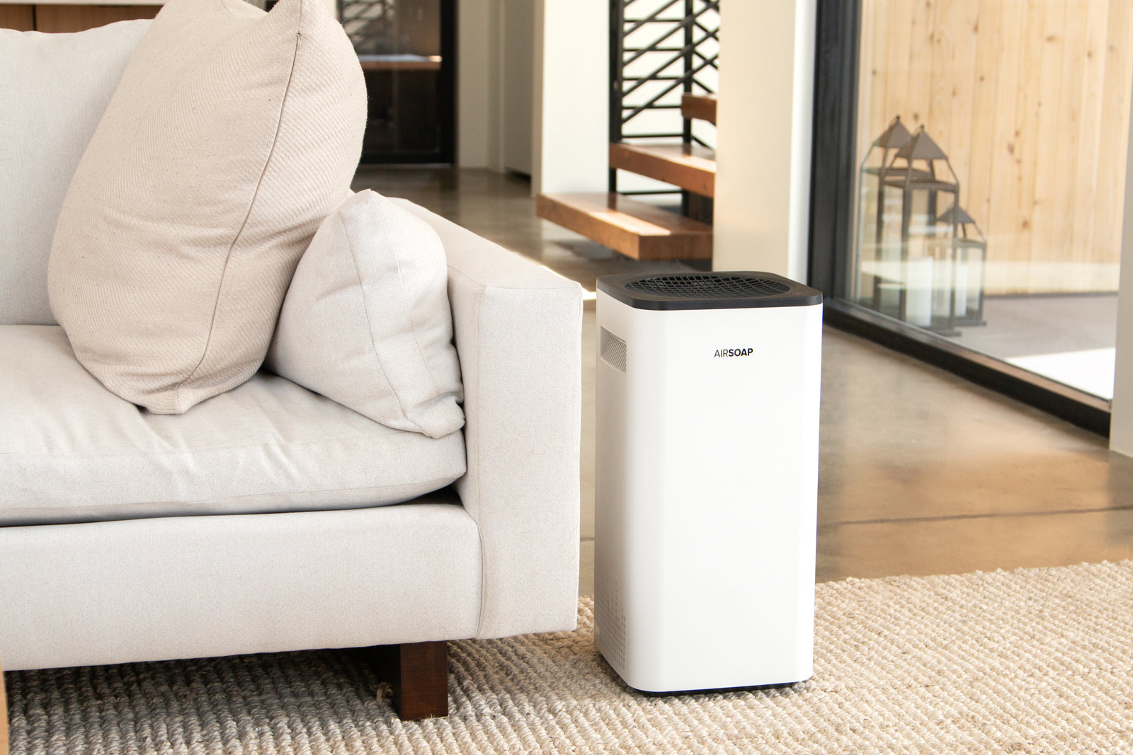 AirSoap air purifier running indoors with wildfire smoke haze outside the window
