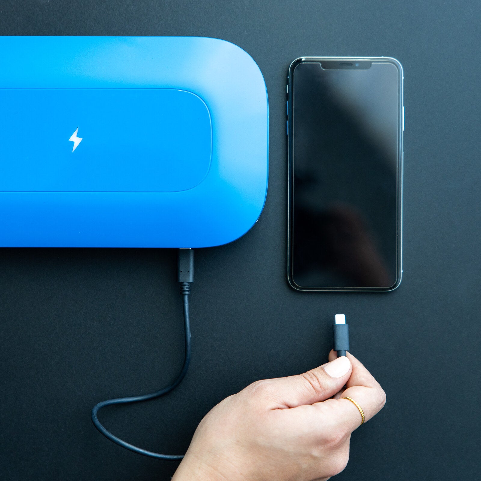 PhoneSoap Pro charging a phone with USB-C while it sanitizes