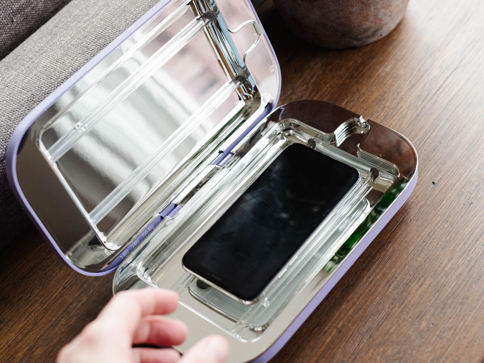 Placing a phone inside the open PhoneSoap Pro chamber
