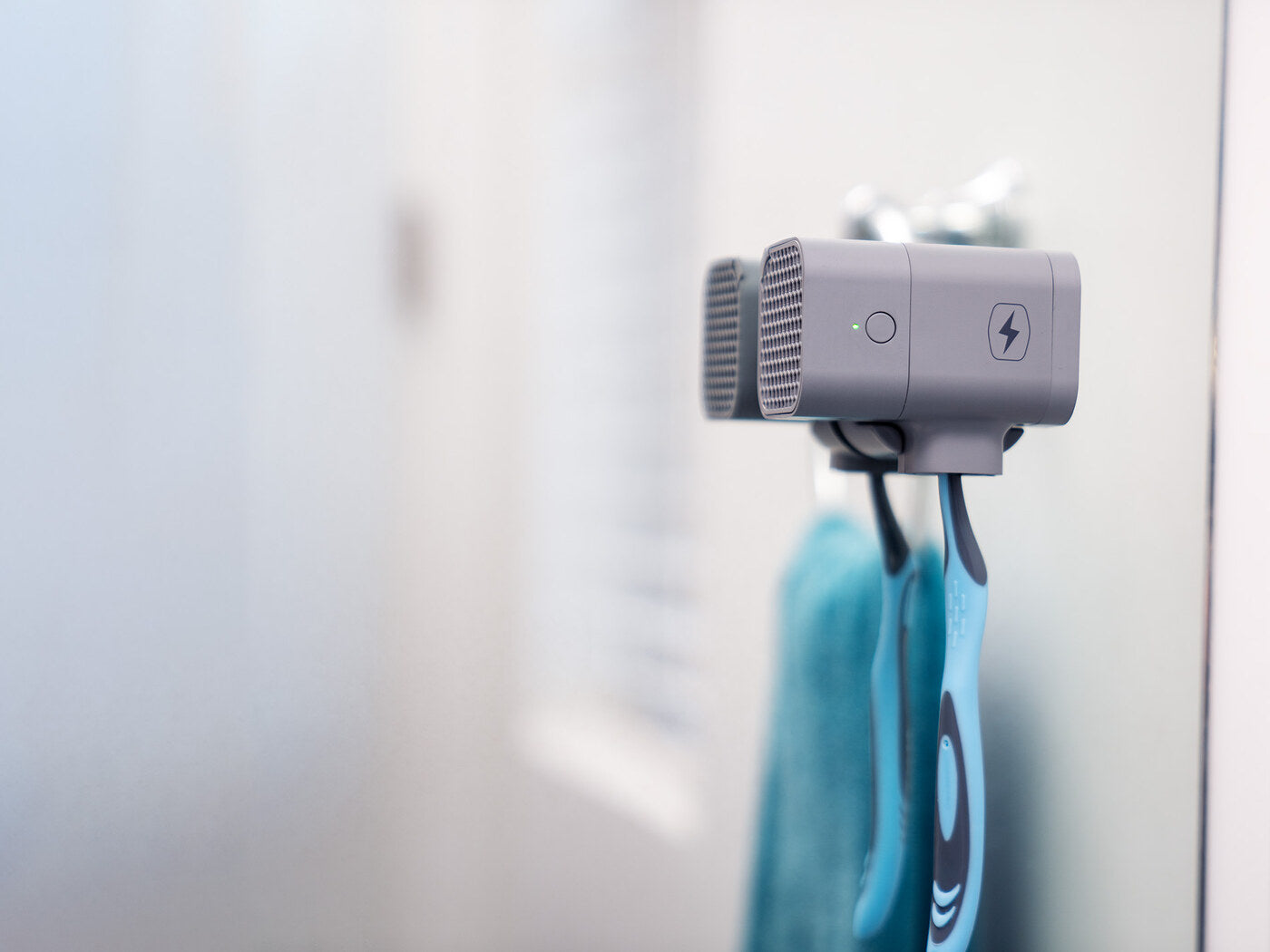 BrushGuard mounted on a bathroom mirror protecting a toothbrush