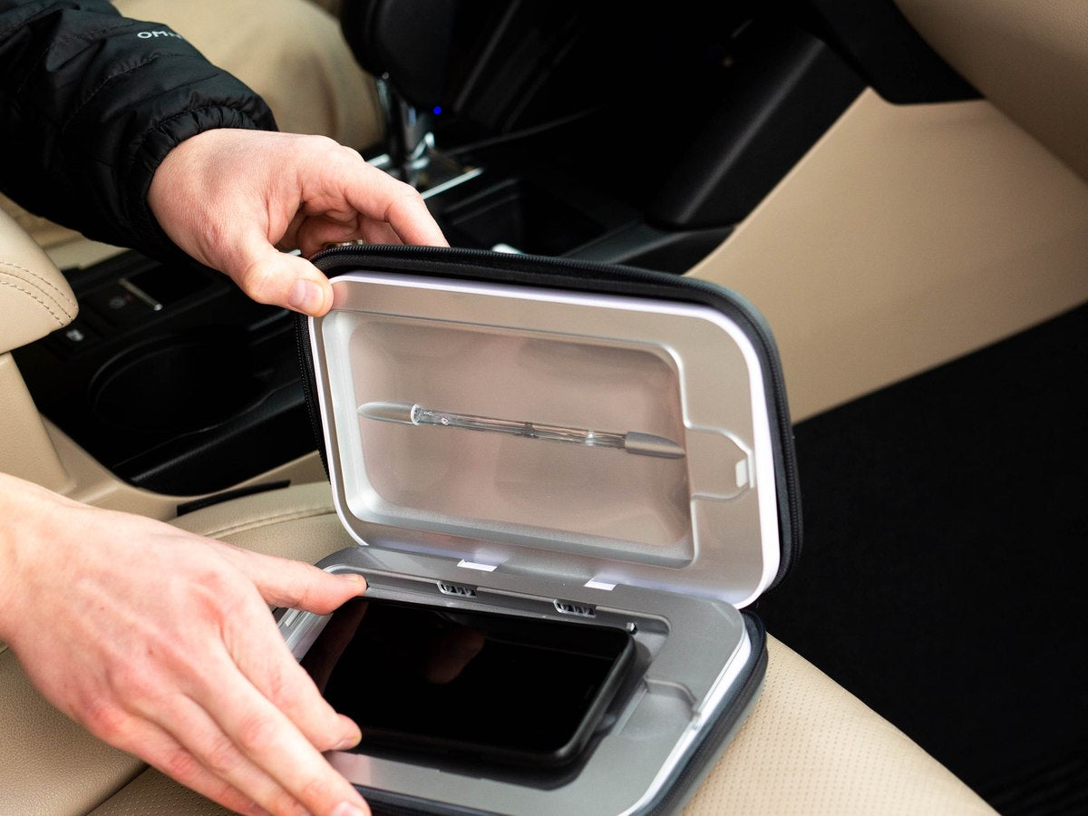 Placing a phone inside the open PhoneSoap Go