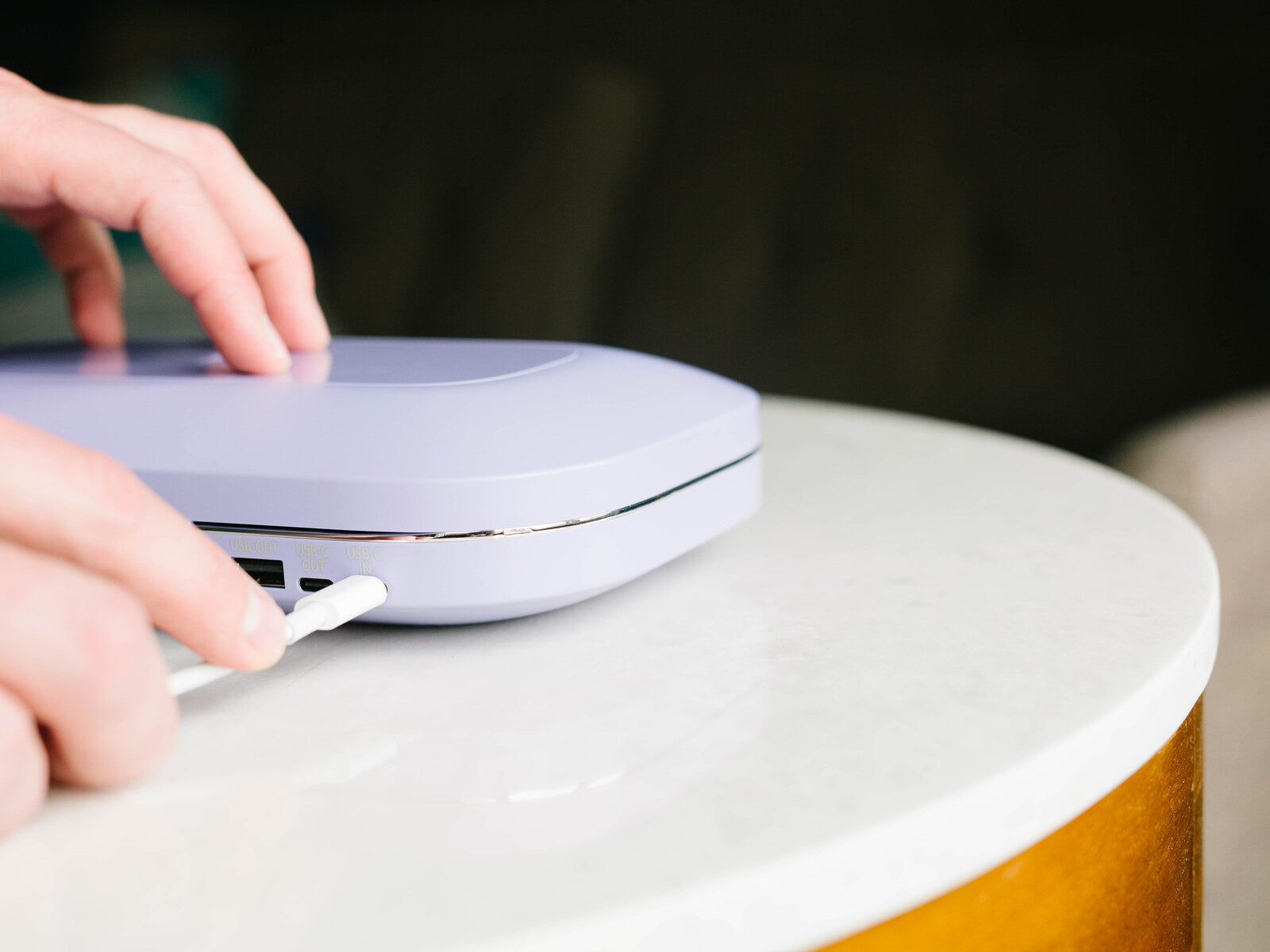 Plugging the charging cable into the PhoneSoap Pro port