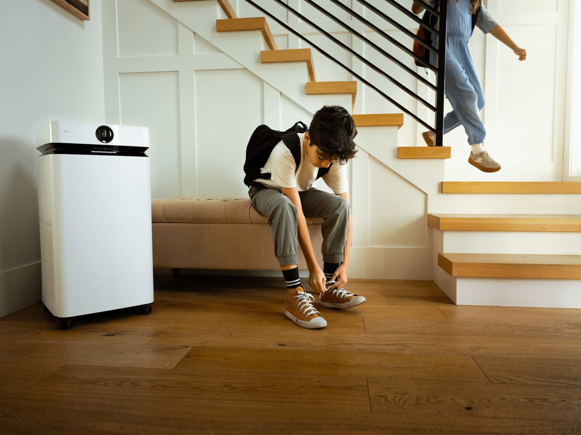 Person sitting on a staircase with the AirSoap X8 in the foreground